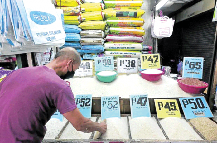 Eddie Pascual, 55, waits for customers at this rice stall in the Marikina public market. FILE PHOTO BY GRIG C. MONTEGRANDE / PHILIPPINE DAILY INQUIRER