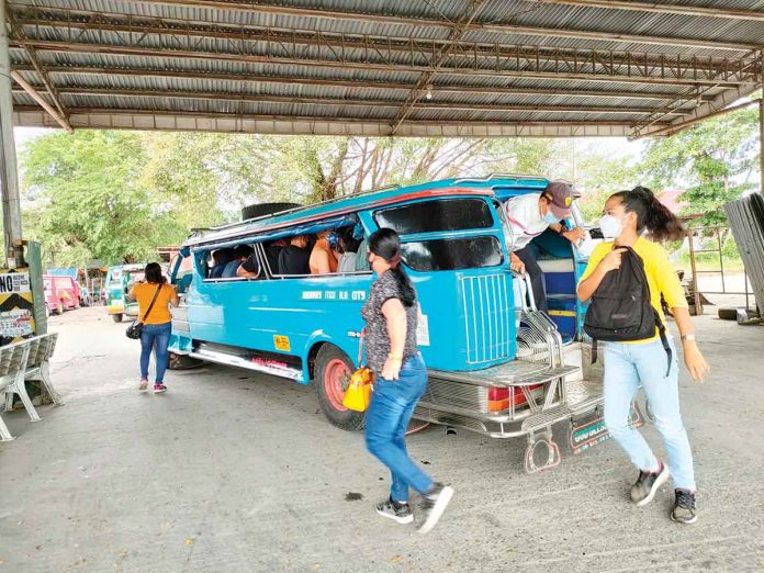 Passengers disembark from a provincial jeepney at the transport terminal in Barangay Ungka, Jaro, Iloilo City. To enter they city they must transfer to a city loop jeepney. PN PHOTO