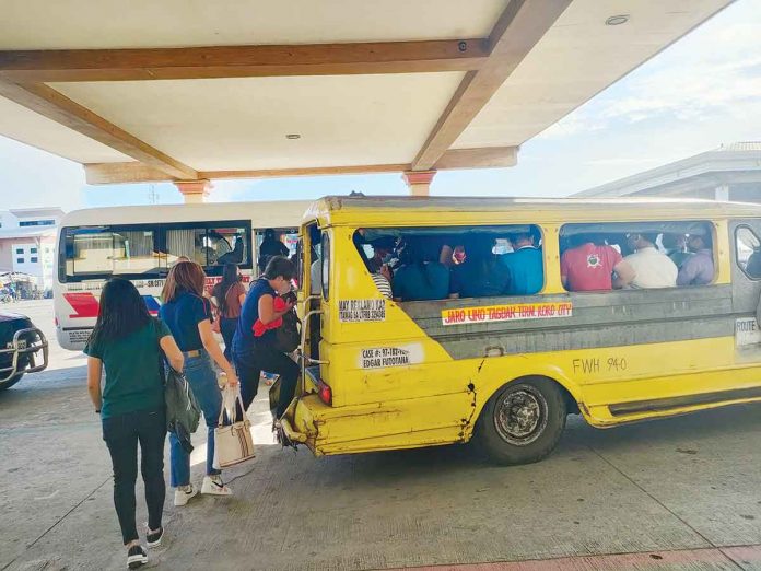 front-glenda-tweak Passengers queue to board a city-bound traditional jeepney at the transport terminal in Barangay Tagbak, Jaro, Iloilo City. The Local Public Transport Route Plan bars provincial jeepneys from entering the city. ARNEL JOHN PALCULLO/PN