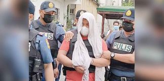 After his inquest, stabbing suspect Mark Archie Torrefiel is whisked away by policemen to the Kalibo police station in Kalibo, Aklan.