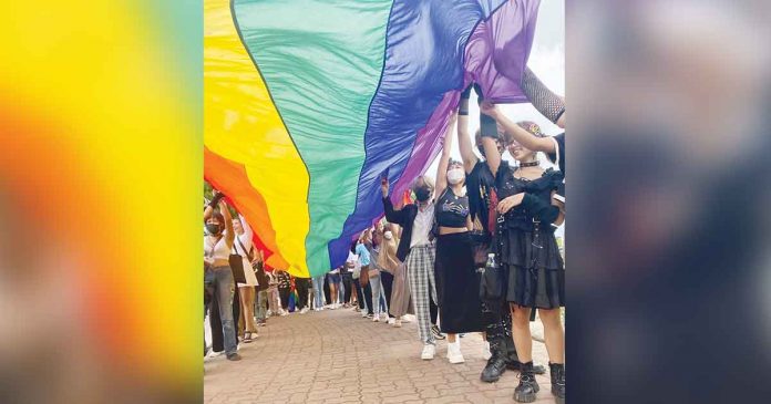 lgbt Members of the LGBTQ community of Iloilo march while holding the rainbow flag, the universal symbol of lesbian, gay, bisexual, transgender and queer social movement. The flag’s colors reflect the diversity of the LGBT community and the wide spectrum of human sexuality and gender. PHOTO FROM ILOILO PRIDE TEAM FACEBOOK PAGE