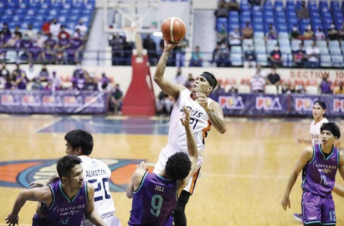 meralco Negrense Reynel Hugnatan of Meralco Bolts attempts a one-hander while being defended by Converge FiberXers’ Tyrus Hill. PBA MEDIA BUREAU