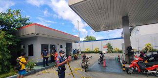 A policeman is securing this robbed gasoline station in Jaro district with a yellow tape. The area is considered a crime scene. PHOTOS FROM ARNEL JOHN PALCULLO/PN