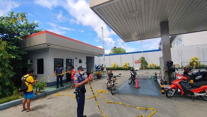 news-gas-station-pic-and-caption A policeman is securing this robbed gasoline station in Jaro district with a yellow tape. The area is considered a crime scene. PHOTOS FROM ARNEL JOHN PALCULLO/PN