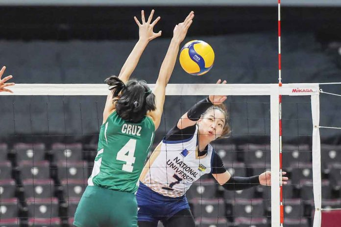 sports-NU Ilongga Princess Ann Robles of National University Lady Bulldogs attempts to score against the defense of De La Salle University Lady Spikers’ Leila Cruz. UAAP MEDIA BUREAU