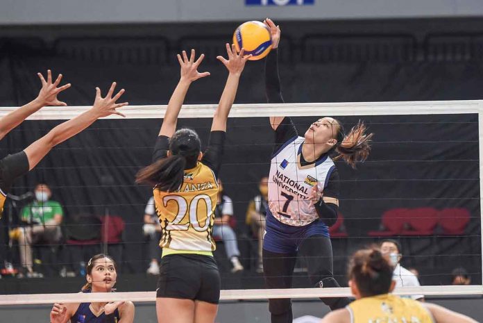 sports-NU-pic-and-caption Ilongga Princess Anne Robles of the National University Lady Bulldogs unloads an attack against the defense of University of Santo Tomas Golden Tigresses' Mafe Galanza. UAAP MEDIA BUREAU