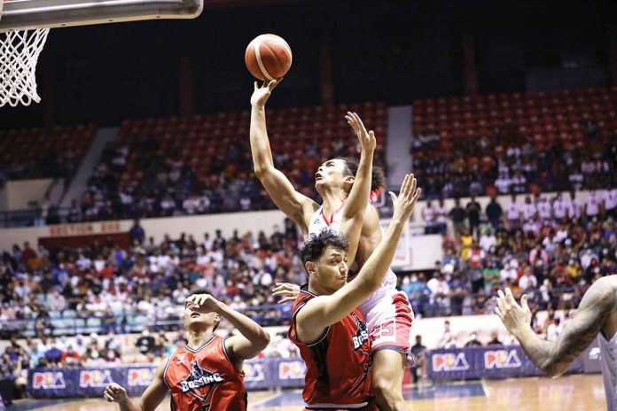sports-aguilar Barangay Ginebra San Miguel Kings’ Japeth Aguilar runs over the defense of Blackwater Bossing’s Yousef Taha for an inside attempt. PBA MEDIA BUREAU