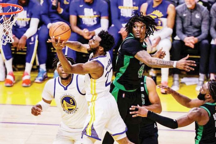 sports-wiggins Golden State Warriors’ Andrew Wiggins eludes the defense of Boston Celtics’ Robert Williams III for a layup. PHOTO COURTESY OF THE CHRONICLE