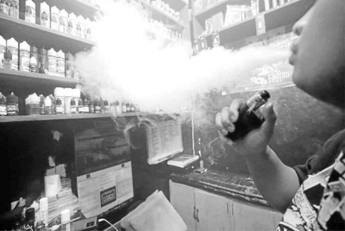 vaping A customer checks out vape flavors at a store in Pasay City. Vaping is the inhaling of a vapor created by an electronic cigarette or other vaping device. E-cigarettes are battery-powered smoking devices. They have cartridges filled with a liquid that usually contains nicotine, flavorings, and chemicals. The liquid is heated into a vapor, which the person inhales. JOAN BONDOC/PHILIPPINE DAILY INQUIRER FILE PHOTO