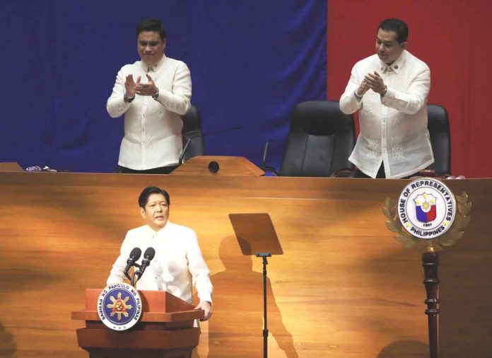 VITAL MEASURES. President Ferdinand “Bongbong” Marcos Jr. urges Congress to pass priority measures of his administration, during his first State of the Nation Address at the Batasang Pambansa Complex in Quezon City on July 25, 2022. Standing behind him are Senate President Juan Miguel Zubiri (left) and House Speaker Martin Romualdez. PNA PHOTO