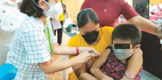 A boy gets a shot of the vaccine against coronavirus disease while being restrained by his mother, in this photo taken during the kickoff of the Iloilo provincial government’s vaccination campaign for young children early this year. PN PHOTO