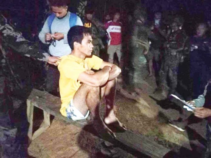 front-most-wanted Fugitive Joel Leyble of Calinog, Iloilo did not resist when policemen served him arrest warrants for rape and attempted murder before dawn yesterday in the remote village of Toyungan in Calinog town. PRO-6 PHOTO