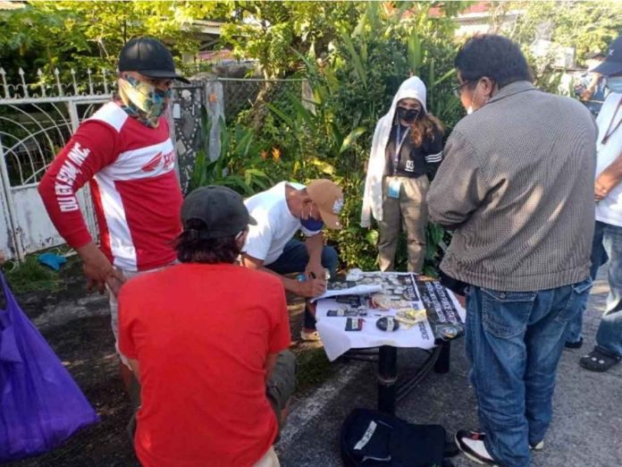 mae-shab Undercover policemen check the items recovered in a buy-bust operation in Bago City, Negros Occidental. Photo by NOCPPO