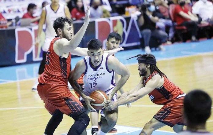 sports-arana Converge FiberXers’ Justin Arana protects the ball from the defense of Blackwater Bossing’s Yousef Taha and Justin Melton. PBA MEDIA BUREAU
