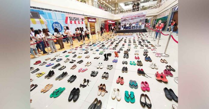 The Iloilo City government through the Iloilo City Anti-Smoking Task Force, in partnership with public interest law group ImagineLaw, sets up an art installation of 321 pairs of footwear at the SM City Iloilo activity center on Friday, July 22, 2022, to commemorate the 321 Filipinos who die everyday due to tobacco-related diseases. The art installation is also part of ImagineLaw’s call for stronger tobacco control policies to protect public health from tobacco companies. AJ PALCULLO