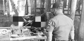 Policemen of Guimaras check the items recovered from a drug suspect in a buy-bust operation. The arrested suspect is seated on the left. JORDAN POLICE STATION PHOTO