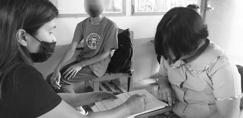 Teacher Cheryl Clarin assists her 18-year-old student. Clarin is handling 12 learners with intellectual disability at the New Lucena Central School SPED Center.