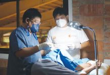 St. Padre Pio Contemplative Prayer Group-Bacolod City’s surgeon Dr. Jundad Legislador, assisted by SMPC Infirmary’s Dr. Paul Jude Melsam Aquino, conducts a minor surgery on a resident.