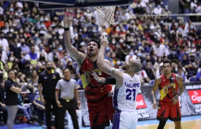 sports san pic and caption TOWER OF POWER! San Miguel Beermen’s June Mar Fajardo easily scores against the defense of TNT Tropang Giga’s Kelly Williams. PBA MEDIA BUREAU