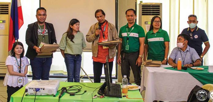 antique Junie Sabusap (4th from right) turns over membership data forms to the Antique Provincial Social Welfare and Development Office. Registered persons with disabilities are automatically registered as Philippine Health Insurance Corporation members and the national government pays their contributions. ANTIQUE PIO PHOTO