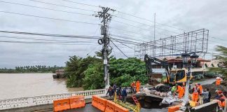 Tropical Storm “Paeng” damaged the Kalibo Bridge (Numancia side) in Aklan, causing it to close temporarily. Motorists and the riding public are advised to use the Kalibo Bridge II. Photo shows a big hole on the approach of the Kalibo Bridge (Numancia side) which, according to the Department of Public Works and Highways-Aklan, was caused by soil erosion underneath the bridge due to the strong floodwater current. ROMAR SMITH PHOTO