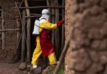 A Red Cross worker sanitizes a house in Mubende, Uganda. GETTY IMAGES