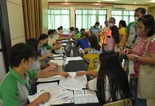PhilHealth personnel facilitate the registration of members in Nueva Valencia, Guimaras to their chosen KonSulTa provider. Below photo: Personnel of Nueva Valencia RHU conducts health screening and profiling of member registered in the RHU.
