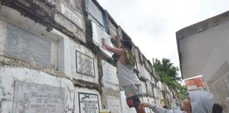 CLEANING TOMBS. This early, family members such as this man at the Pavia Catholic Cemetery in Pavia, Iloilo start cleaning the tombs of their departed loved ones in preparation for the observance of “Piesta Minatay”. AJ PALCULLO/PN