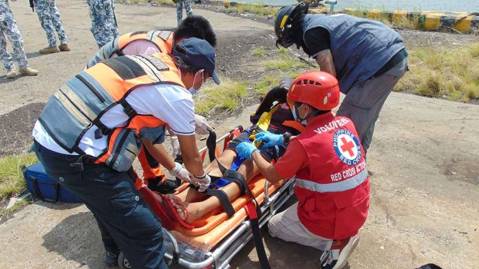 simulation-2 A member of the Philippine Coast Guard (PCG) posing as the vessel's passenger was treated by personnel from the Philippine Red Cross and the Bacolod City Disaster Risk Reduction and Management Office during the PCG-Northern Negros Occidental’s search and rescue and oil spill simulation exercise at Banago Port on Oct. 19. CGS-NORTHERN NEGROS OCCIDENTAL