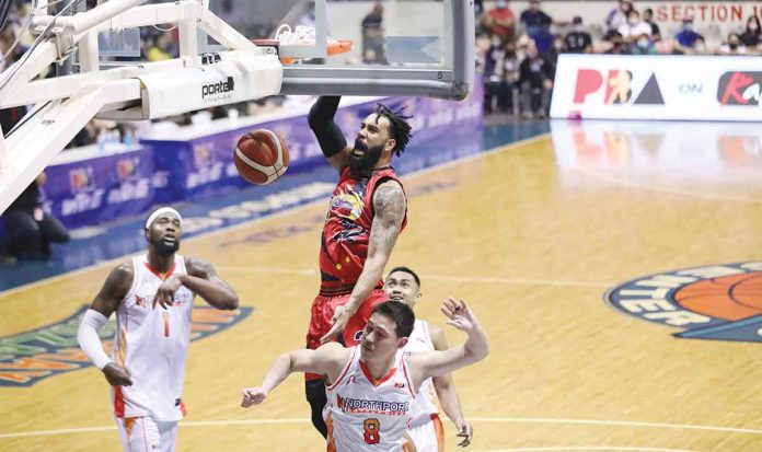 sports-San-Miguel San Miguel Beermen’s Devon Scott attacks the defense of NorthPort Batang Pier’s Robert Bolick Jr. with a one-handed dunk. PBA MEDIA BUREAU
