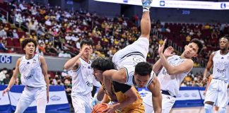 Adamson University Falcons’ Joshua Yerro loses his balance as he tries to stop University of Santo Tomas Growling Tigers’ Kenji Duremdes from scoring inside. UAAP PHOTO