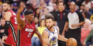 Stephen Curry of the Golden State Warriors is guarded by Jimmy Butler of the Miami Heat during their 2022-2023 NBA Season game at Chase Center in San Francisco, California. PHOTO BY EZRA SHAW/GETTY IMAGES