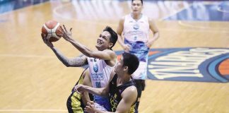 Phoenix Super LPG Fuel Masters’ Encho Serrano charges to the defense of TNT Tropang Giga’s Calvin Oftana for a layup. PBA MEDIA BUREAU