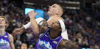 Utah Jazz’s Jarred Vanderbilt locks arms with Denver Nuggets’ Nikola Jokić during a rebound battle. AP