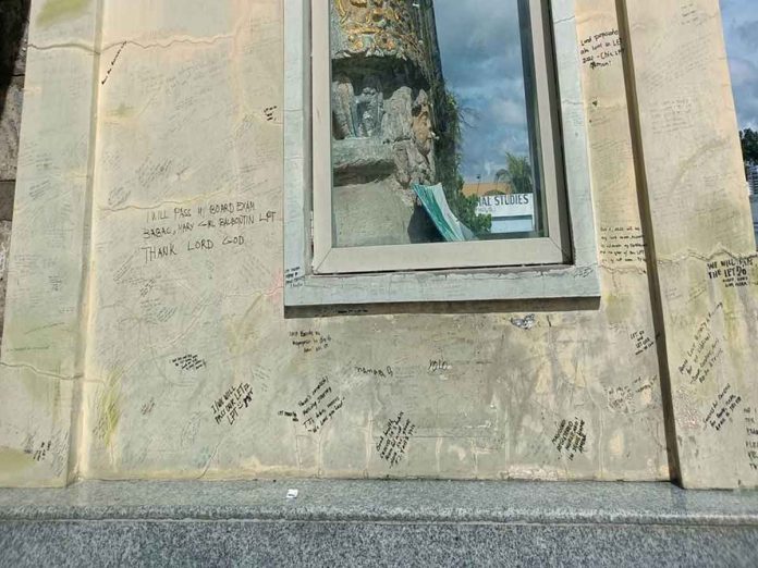 vandal-pic-and-caption Fr. Angelo Colada, Social Communications Director of the Archdiocese of Jaro, says he understood that the would-be takers of the licensure examination for teachers have good intentions in "vandalizing" the National Shrine of our Lady of Candles. The action, however is bad.