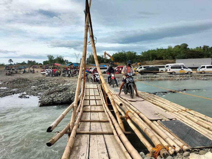 The bulk of funds needed to restore storm-damaged infrastructures in Western Visayas will go to the province of Antique, data from the Department of Public Works and Highways show. Photo shows motorcycles crossing a makeshift bridge at the Paliwan River in Antique. PROVINCE OF ANTIQUE FACEBOOK PAGE PHOTO