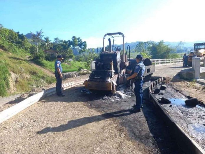 heavy-equipment Members of the New People’s Army allegedly torched a backhoe and a road roller in Purok Magboto, Barangay Cabi-an, Candoni, Negros Occidental on Nov. 5, 2022. CANDONI PNP PHOTO