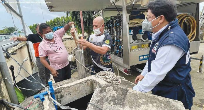 mobile-WTP Department of Health Region 6 director Adriano Suba-an (right) says the town of Sigma in Capiz requested the use of the mobile water processing unit "for a while" as water sources in the area are still being fixed for utilization. PIA-6 PHOTO