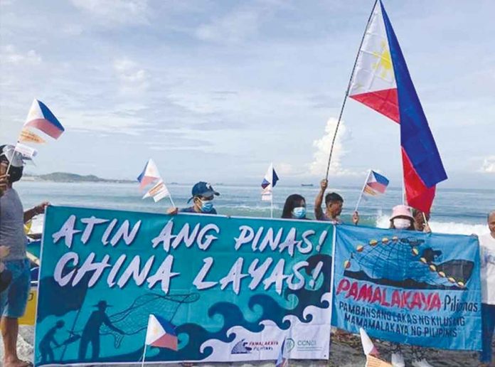 nation3 Members of Pamalakaya stage a seaside protest in Zambales on June 12, 2021, against Chinese incursions in the West Philippine Sea. PHOTO BY PAMALAKAYA