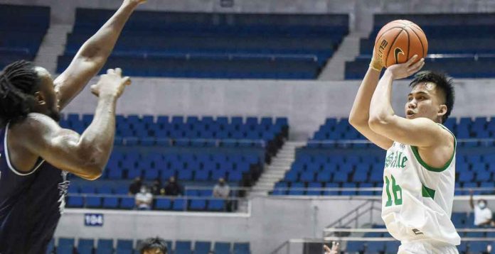 Cyrus Austria scored the game-winning triple for De La Salle University Green Archers while being defended by Adamson University Falcons' Lenda Douanga. UAAP PHOTO
