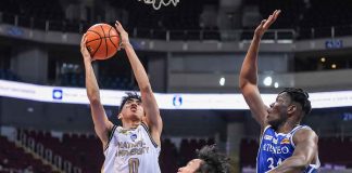 National University Bulldogs’ Jolo Manansala goes for an inside hit as Ateneo de Manila University Blue Eagles’ Angelo Kouame attempts for a block. UAAP PHOTO