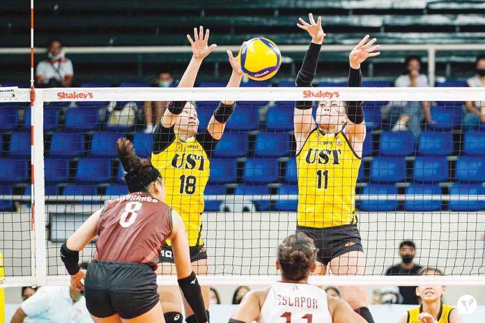 sports-UST University of Santo Tomas Golden Tigresses’ Regina Jurado and Athena Abbu foil the attack of Bacolodnon Joan Marie Monares of the University of the Philippines Fighting Maroons. VARSITARIAN SPORTS PHOTO