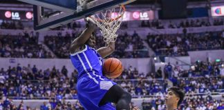 Ateneo de Manila University Blue Eagles’ Angelo Kouame scores on a two-handed dunk as University of the Philippines Fighting Maroons’ Carl Tamayo looks on. UAAP PHOTO