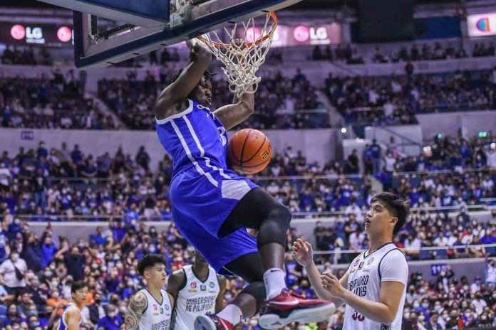 sports-ateneo Ateneo de Manila University Blue Eagles’ Angelo Kouame scores on a two-handed dunk as University of the Philippines Fighting Maroons’ Carl Tamayo looks on. UAAP PHOTO