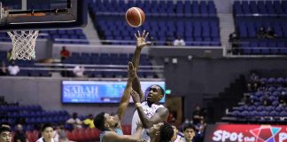 Converge FiberXers’ Quincy Miller scores a floater against the defense of Phoenix Super LPG Fuel Masters' Kaleb Wesson. PBA PHOTO