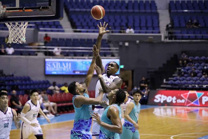 sports-converge Converge FiberXers’ Quincy Miller scores a floater against the defense of Phoenix Super LPG Fuel Masters' Kaleb Wesson. PBA PHOTO
