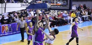 Converge FiberXers’ Justin Arana still managed to put up a shot despite being clobbered by the defense of two Rain or Shine Elasto Painters. PBA MEDIA BUREAU