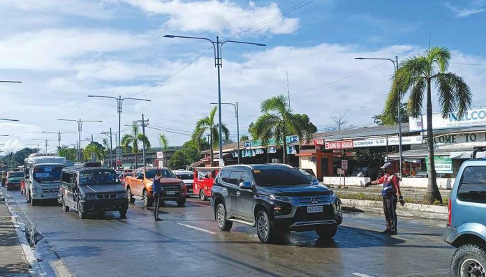 traffic-pic Iloilo City Public Safety and Transportation Management Office (PSTMO) personnel are not allowed to go on holiday break from Dec. 1 to 31 to make sure streets are well-managed in anticipation of the holiday traffic, according to office chief Jeck Conlu. Photo shows two traffic aides directing the flow of vehicles in front of the transport terminal in Barangay Ungka, Jaro district. AJ PALCULLO/PN