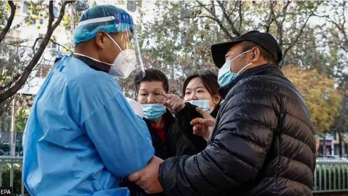 world1 Desperate Chinese citizens confront a healthcare worker. EPA