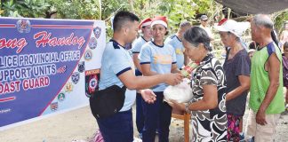 Each recipient family from Barangay Magdalena, San Remigio, Antique receives a food pack containing rice and canned goods as early Christmas gift from the Antique Police Provincial Office on Dec. 1. PCADG WESTERN VISAYAS FACEBOOK PAGE PHOTO